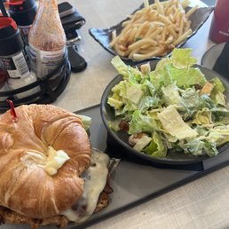 Bbq grilled chicken sandwich with a side ceases salad and fries Bbq grilled chicken sandwich with a side ceases salad and fries