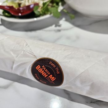 Paris Banh Mi - a plate of food and a bowl of salad - Burgers Near Me - Windsor Heights, Iowa Paris Banh Mi - a plate of food and a bowl of salad - Burgers Near Me - Windsor Heights, Iowa