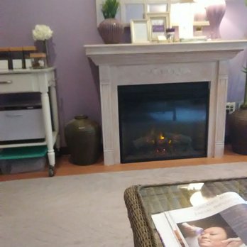 Calvert Rejuvenations Spa - The fireplace and photo book of services in the oasis room - Massage Near Me - Herndon, Virginia