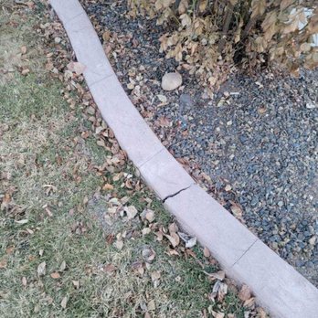 208 Irrigation and Landscape - a concrete edging along the edge of a lawn - Landscaping Near Me