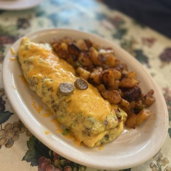 Omelette Inn - #3: hobo: hickory smoked bacon, sausage, Black Forest ham, bell peppers, green onions, cheddar cheese with home fries = $16.75 - Breakfast & Brunch Near Me - Long Beach, California