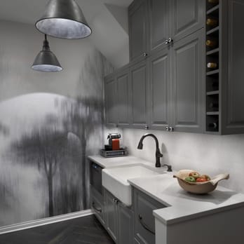 New Concept 180 - a kitchen with grey cabinets and white countertops - General Contractors Near Me New Concept 180 - a kitchen with grey cabinets and white countertops - General Contractors Near Me