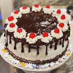 Kakes - Gluten free Black Forest cake with fresh cherry filling, whipped frosting, chocolate ganache drip and candied cherries on top.