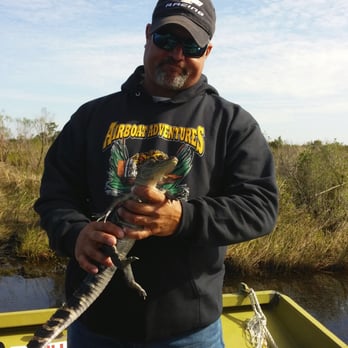Airboat Adventures - Our quirky, energetic, and extremely knowledgable tour guide, holding the baby alligator that all of us got to hold - Boat Tours Near Me - Lafitte, Louisiana Airboat Adventures - Our quirky, energetic, and extremely knowledgable tour guide, holding the baby alligator that all of us got to hold - Boat Tours Near Me - Lafitte, Louisiana