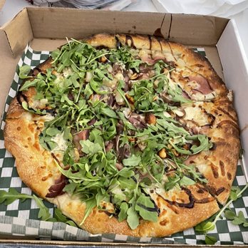 Laughing Buddha - Hala Kahiki Aki Garlic oil base, mozzarella, caramelized onions, pineapple, prosciutto, arugula and cashew drizzled with balsamic - Pubs Near Me - Sudbury, Ontario