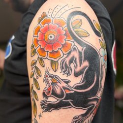 High Priestess Piercing & Tattoo - Cougar and flower tattoo bye Rae.