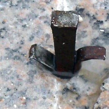 Millennium Granite - a close up of a hammer on a granite slab - General Contractors Near Me - Wells, Maine