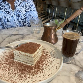 Hamsa - Turkish coffee and a creamy and delicious dessert similar to tiramisu without the coffee flavor. - Mediterranean Near Me - Houston, Texas Hamsa - Turkish coffee and a creamy and delicious dessert similar to tiramisu without the coffee flavor. - Mediterranean Near Me - Houston, Texas