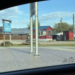 Alpine Air Coffee Hut - Pic from my car window at the 4 way intersection nearby -- the coffee stand is that little red hut in that parking lot!