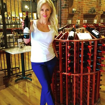Courtyard Winery - a woman holding a bottle of wine - Wineries Near Me - Pittsburgh, Pennsylvania Courtyard Winery - a woman holding a bottle of wine - Wineries Near Me - Pittsburgh, Pennsylvania