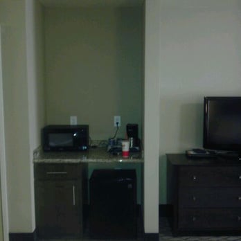Holiday Inn Express & Suites Williston - Mini fridge freezer combo and mini micro in their own cubby space also a small granite counter space with coffee pot & cabinet - Hotels Near Me - Williston, North Dakota