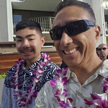Paina Waikiki Luau - Father and Son enjoying a Waikiki Luau. - Polynesian Near Me - Honolulu, Hawaii