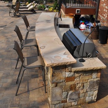 PaverStone Construction, Inc. - a patio with a bar and chairs - Landscaping Near Me - Atlanta, Georgia