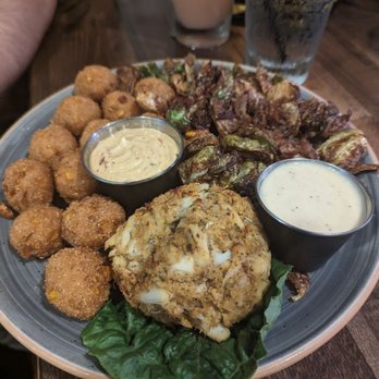 Alexander's Tavern - Crab cake with hush puppies and Brussels sprouts - Bars Near Me - Baltimore, Maryland Alexander's Tavern - Crab cake with hush puppies and Brussels sprouts - Bars Near Me - Baltimore, Maryland