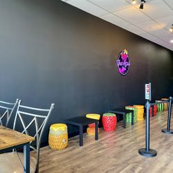 The Acai Spot - Small tables and fruit-themed chairs