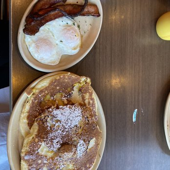 Snooze, an A.M. Eatery - Pineapple upside down pancakes with a side of bacon and 2 over easy eggs. - Breakfast & Brunch Near Me - Denver, Colorado Snooze, an A.M. Eatery - Pineapple upside down pancakes with a side of bacon and 2 over easy eggs. - Breakfast & Brunch Near Me - Denver, Colorado