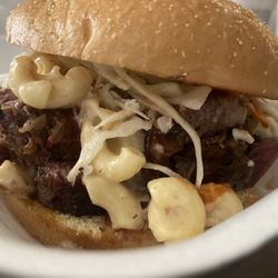 Big Tex BBQ - Brisket Sandwich , layered with their Smoked Mac and Cheese ,  Coleslaw and BBQ Sauce.