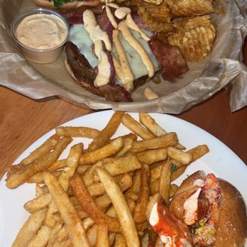 The Boardwalk - Cajun burger with a side of house chips, Boardwalk Lobster Roll with a side of French fries - Seafood Near Me - Put In Bay, Ohio The Boardwalk - Cajun burger with a side of house chips, Boardwalk Lobster Roll with a side of French fries - Seafood Near Me - Put In Bay, Ohio