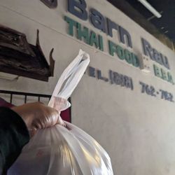 Barnrau Thai Halal Cuisine - Packed food and outside sign on wall
