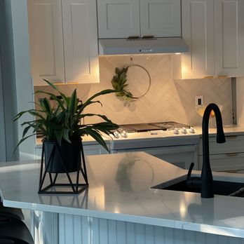 Finishing Touches Construction - a kitchen with white cabinets and white countertops - General Contractors Near Me - Charlotte, North Carolina
