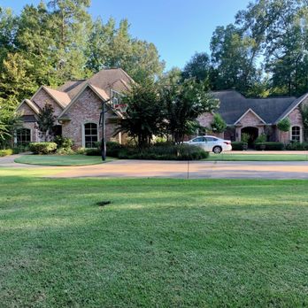 Glover's Lawn Care - a car parked in front of a house - Lawn Services Near Me