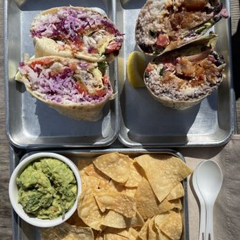 Hook Fish - Fried fish of the day burrito w/o beans (left), poke burrito w/beans (right), and guacamole chips - Seafood Near Me - San Francisco, California Hook Fish - Fried fish of the day burrito w/o beans (left), poke burrito w/beans (right), and guacamole chips - Seafood Near Me - San Francisco, California