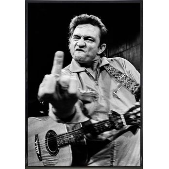 Guerrilla Graphix - A black-and-white photograph features a man with a stern facial expression, raising his middle finger towards the camera. He is holding an acoustic guitar and appears to be in a casual setting. The background is dark and plain, emphasizing the subject's gesture and facial expression. - Printing Services Near Me - Albuquerque, New Mexico