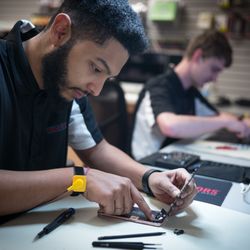 Experimax West Houston - Nicholas works on a iPhone 6
