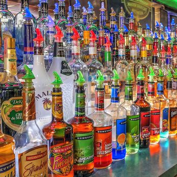Rex's Rendezvous - bottles of liquor lined up on a bar - American Near Me - Warsaw, Indiana Rex's Rendezvous - bottles of liquor lined up on a bar - American Near Me - Warsaw, Indiana