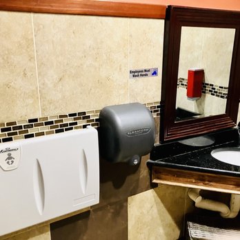Pho79 - a bathroom with a sink, mirror and soap dispenser - Vietnamese Near Me - Hampton, Virginia