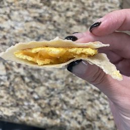 a hand holding a half eaten taco a hand holding a half eaten taco