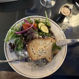 Gluten free chicken sandwich with salad.