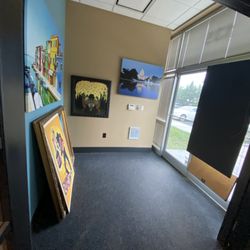 KH Art & Framing - Front entrance with artwork on the wall for sale. Come get your cherished artwork framed!