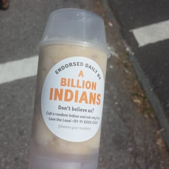 Monsieur Singh Lassi - a person holding a container of indian food - Street Vendors Near Me Monsieur Singh Lassi - a person holding a container of indian food - Street Vendors Near Me