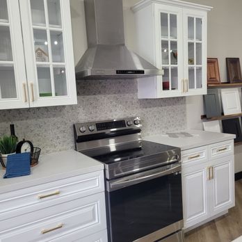 Dustin Smith Construction - a kitchen with white cabinets and stainless steel appliances - General Contractors Near Me Dustin Smith Construction - a kitchen with white cabinets and stainless steel appliances - General Contractors Near Me