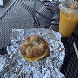 Munkabeans - Egg and Cheddar Croissant with sausage and a mango smoothie.