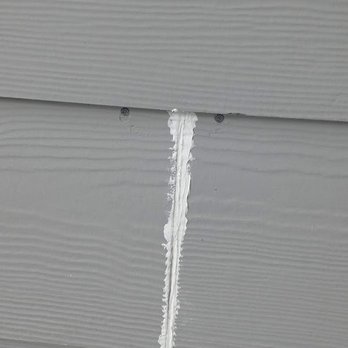 Armour Contracting - a crack in the siding of a house - General Contractors Near Me