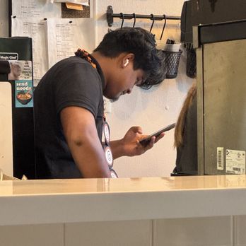 Urban Vietnamese - Employee getting paid to stare at his phone - Vietnamese Near Me - Jacksonville, Florida