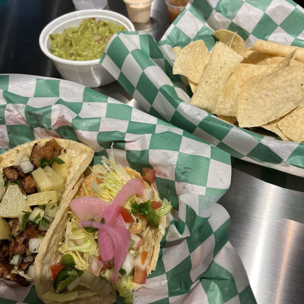 Al pastor taco, fried shrimp taco, and an order of guacamole. Al pastor taco, fried shrimp taco, and an order of guacamole.