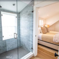 Ackceptional Luxury Nantucket Rentals - An ensuite room with a marble shower.