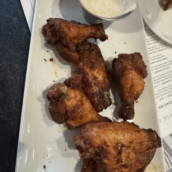 Burtons Grill & Bar - Dry rubbed wings with some feathers still attached. - New American Near Me - Boca Raton, Florida