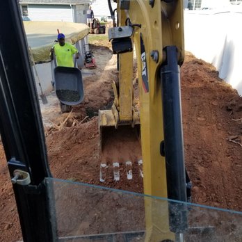Greener Solutions Landscaping - a backhoe of a bulldozer - Snow Removal Near Me Greener Solutions Landscaping - a backhoe of a bulldozer - Snow Removal Near Me