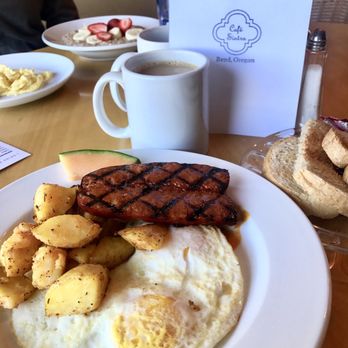 Sintra Restaurant - Two egg brekkie with linguiça and a house coffee. Oatmeal with fresh fruit and a side egg in the background - Breakfast & Brunch Near Me - Bend, Oregon Sintra Restaurant - Two egg brekkie with linguiça and a house coffee. Oatmeal with fresh fruit and a side egg in the background - Breakfast & Brunch Near Me - Bend, Oregon