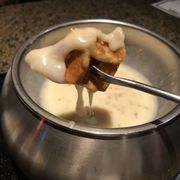 Photo of The Melting Pot - Jenks, OK, United States. Belgian waffle dipped in the incredible Creme Brulee fondue