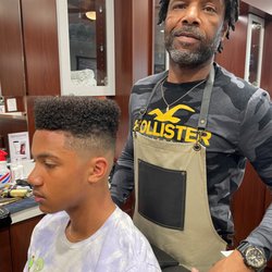 Roosters Men's Grooming Center - Anthony finishing up a precision fade.