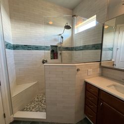 Mann Tile - Bath Remodel in Placida. We added light to the bath by lowering the wall, re-tiling, and adding glass.