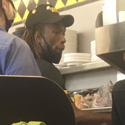 Photo of worker not wearing a mask properly while preparing food Photo of worker not wearing a mask properly while preparing food