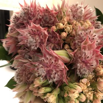 UrbanStems - Blushing Bride bouquet. I added the small pink flowers and greenery as fillers to make the bouquet look fuller along with the ribbon. - Florists Near Me