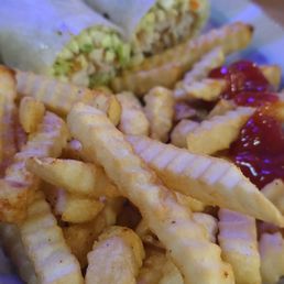 Fries with fish wrap in the back Fries with fish wrap in the back