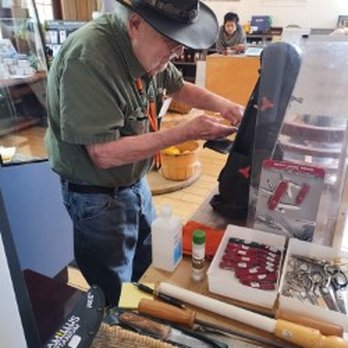 Tiny Grocer ABQ - Sharpening a knife on a grinding stone - Coffee & Tea Near Me - Albuquerque, New Mexico